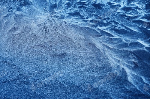 Preview: Frosty Patterns. Close-up of intricate frost designs on a blue surface,