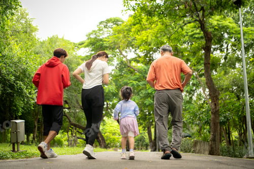 Preview: Asian family jogging together in the park. Parents, child, and grandfather exercising outdoors