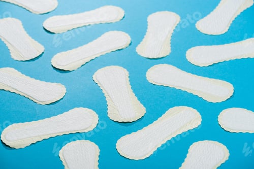 Preview: scattered protective daily pads on blue