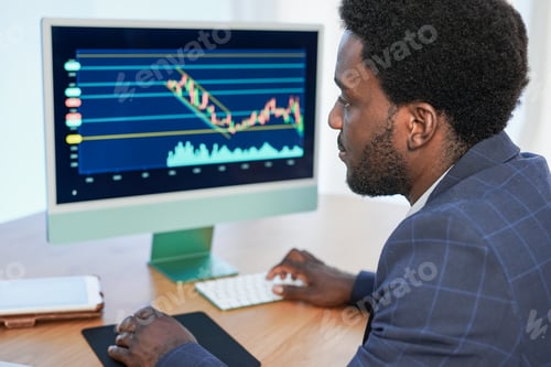 Preview: Africna business man using computer and tablet doing blockchain analysis
