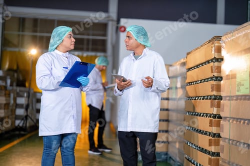 Preview: In warehouse quality control team checking drinking bottle stack on pallet before delivery