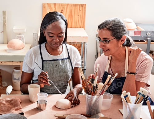 Preview: Women painting pottery in workshop