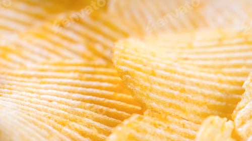 Preview: Yellow Crispy Ridged Potato Chips Close Up. Food Background