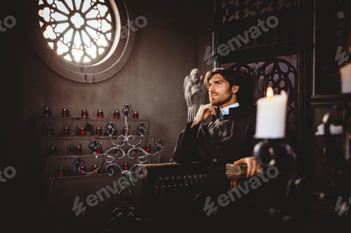 Preview: Priest reading and praying in the church