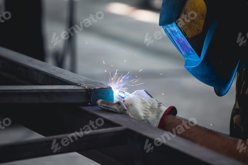 Preview: Industry worker welding iron pieces at work