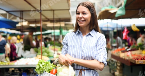 Preview: Picture of woman at marketplace buying vegetables