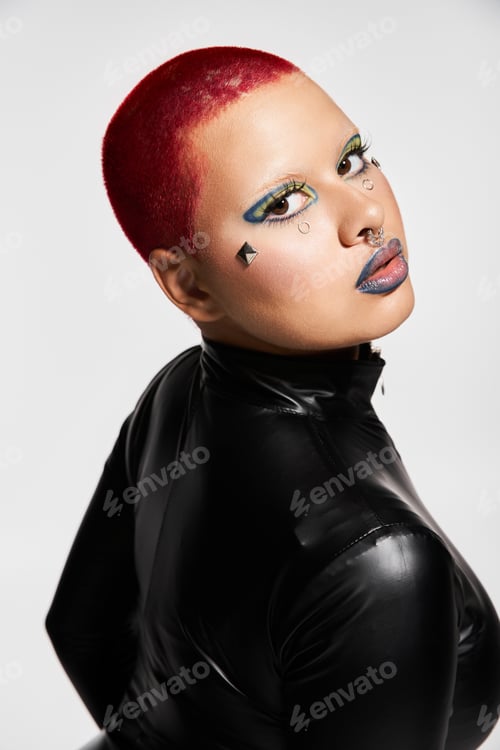 Preview: A young woman with bright pink hair showcases her unique style in a modern studio