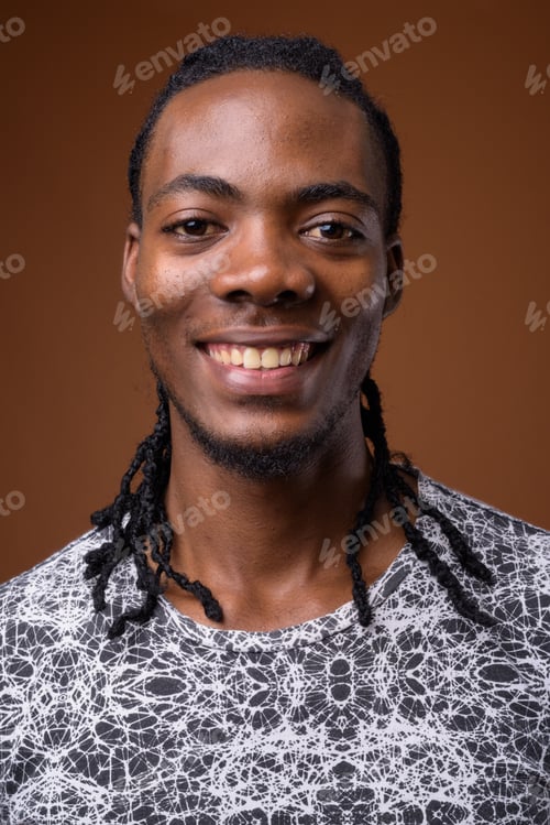 Preview: Young handsome African man against brown background