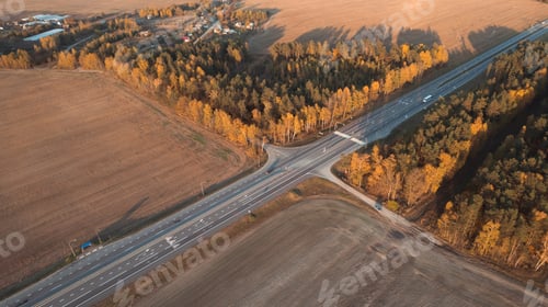 Preview: Aerial view of intercity road with fast driving cars between autumn forest trees