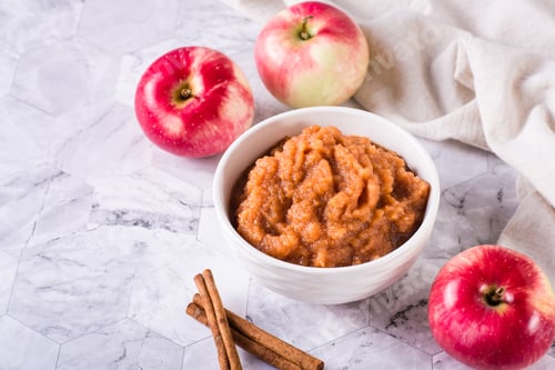 Preview: Homemade applesauce in a bowl and fresh fruit on the table. Organic food.