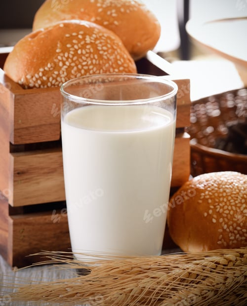 Glass of Milk with Fresh Buns and Wheat