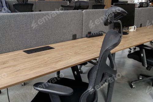Preview: Empty workplace with table and chair at open space office interior.