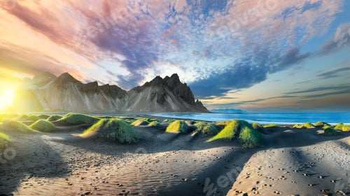Preview: Impressive sunset with gorgeous black sand dunes on Stokksnes cape in Iceland.