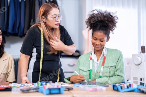 Preview: Senior fashion designer teamwork discuss teach learner final design share idea in shop lady tailor