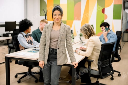 Preview: Confident businesswoman smiling standing in modern office
