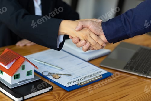 Preview: Handshake after reaching a real estate deal. Signing a house rental agreement.