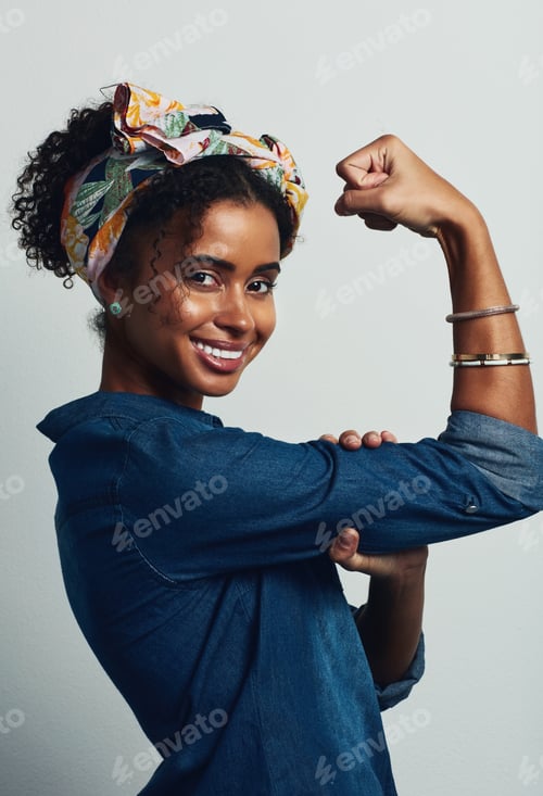 Preview: Studio shot of an attractive young woman posing against a grey background