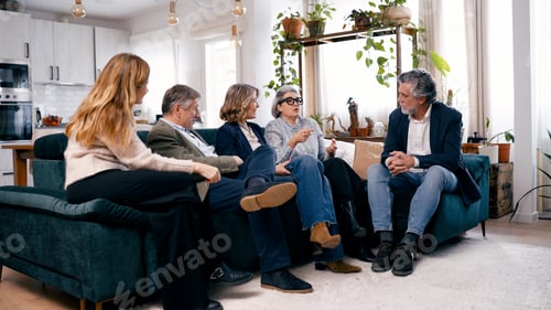 Preview: Senior friends having conversation during social gathering at home