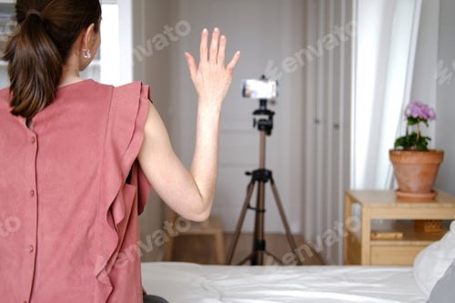 Preview: Woman Demonstrating in Pink Top with Hand Raised