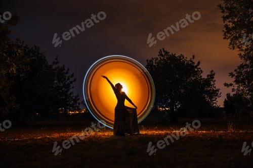 Preview: Female silhouette in glowing circle in nature