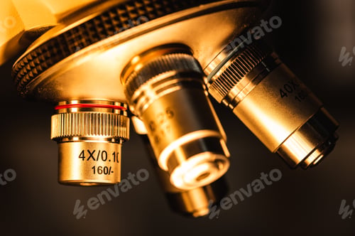 Preview: Close-up shot of professional scientific microscope with metal lens setting at medical laboratory