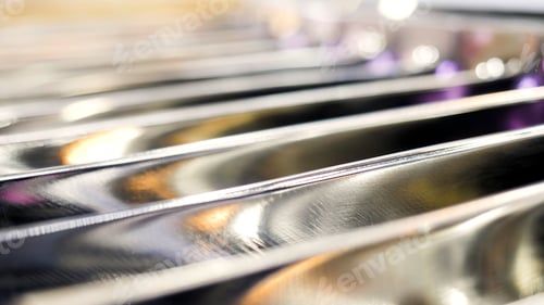 Vista previa: Close up of metal blurred parallel bars with blinking small light bulbs. Media. Industrial