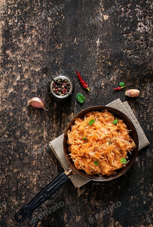 Preview: Stewed cabbage on the old wooden background in rustic style. Top view