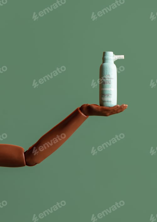 Preview: african-american female doll hand hold lotion on green background