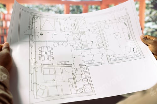 Preview: Professional businessman reviewing architectural blueprints for new office hunt
