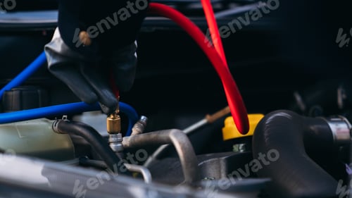 Preview: Close up hand of Mechanics inspect and check the refrigerant and fill the car air conditioner.