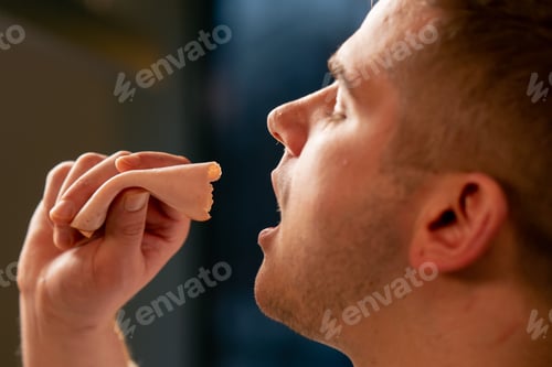 Preview: a young guy in love guy in a beautiful kitchen eating shredder background sunset sun on the leaves