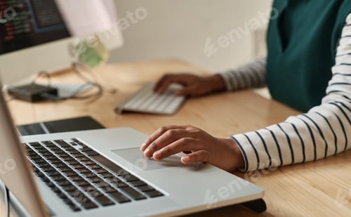 Preview: Hand of young black woman over laptop touchpad during network