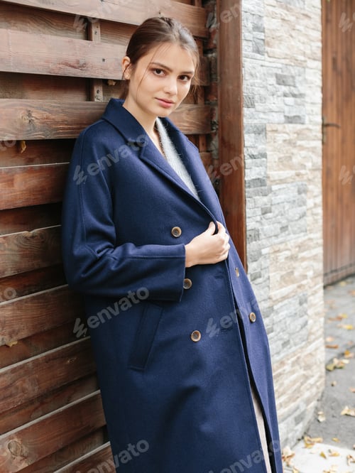 Preview: Happy business woman walking at beautiful autumn city street wearing colorful scarf and warm coat