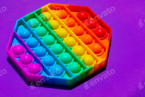 Preview: Colorful antistress pop it toy on purple background
