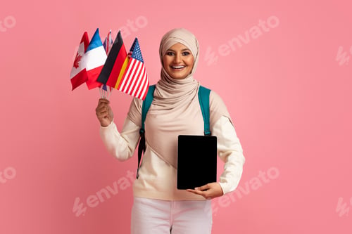 Preview: Online Language Courses. Muslim Woman Holding International Flags And Blank Digital Tablet
