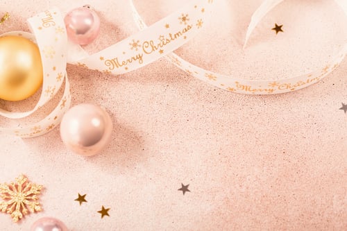 Preview: Festive Christmas and New Year background with gold and pink baubles and ribbons
