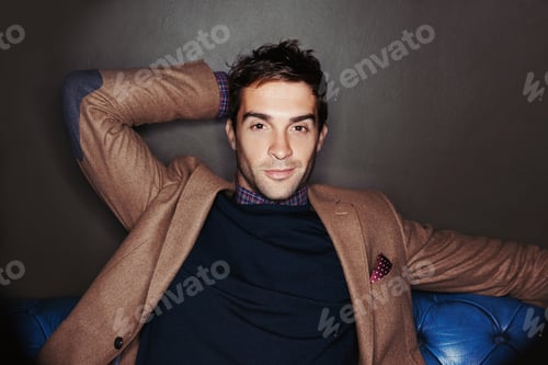 Preview: Waiting for my friends. Portrait of a stylish young man sitting on a leather couch.