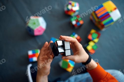 Preview: Male child play with puzzle cubes