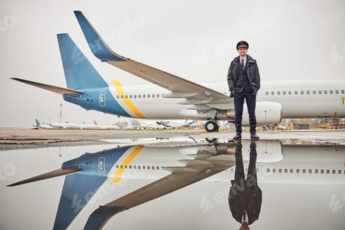 Preview: Portrait of happy confident caucasian airplane crew near plane