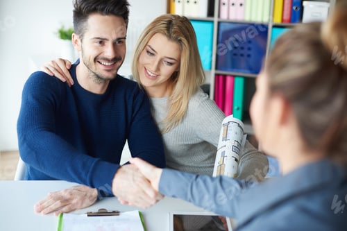 Preview: Happy Couple Shakes Hands with Real Estate Agent
