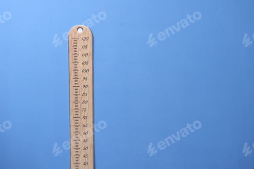 Preview: Height measuring chart on blue wall indoors, space for text