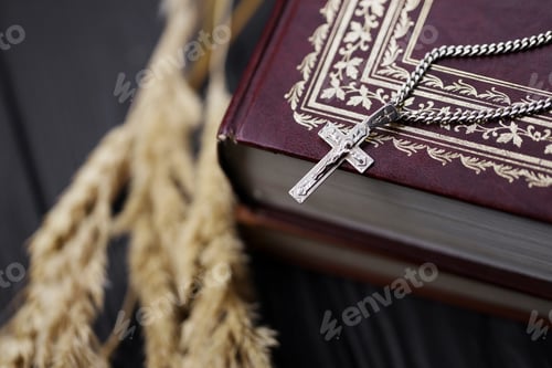 Preview: Silver necklace with crucifix cross on christian holy bible book on black wooden table