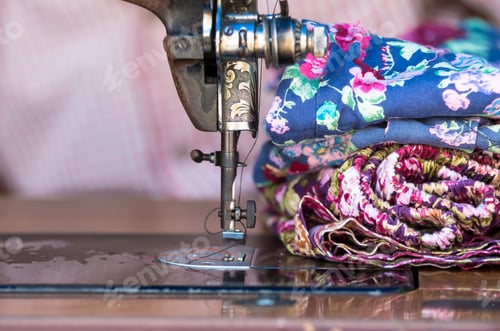 Preview: The vintage sewing machine beside clothes on fashion designer blur background
