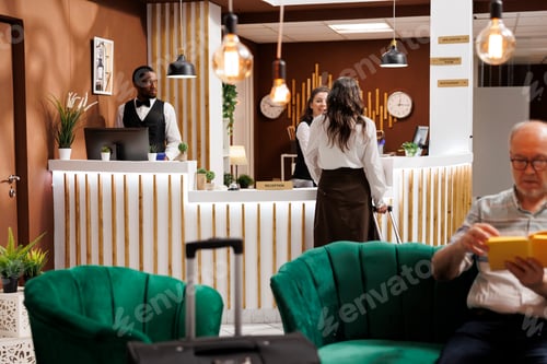 Preview: Friendly hotel staff welcoming seniors