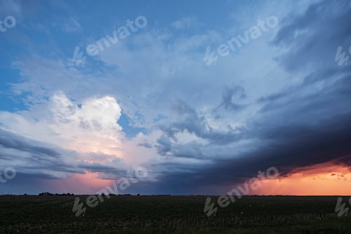 Preview: Approaching storm clouds with lightning in Nebraska, a blue sky background, a lightning bolt