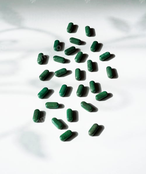 Preview: Pills of chlorella, spirulina, barley grass on white background with dark shadows and shadow pattern