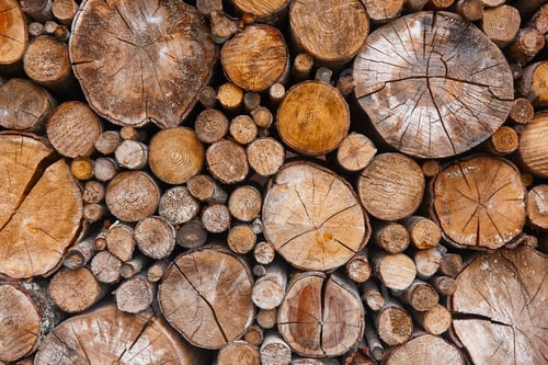 Preview: Stacked tree trunks detail. Finland lumber industry. Nature background. Horizontal