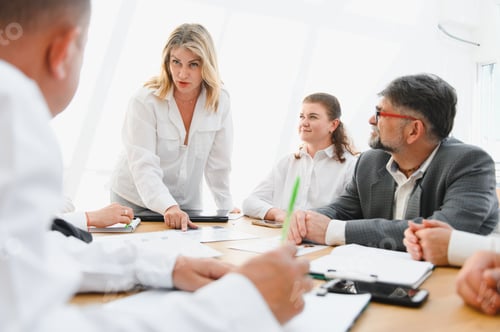 Preview: Business team analyzing data and discussing strategy during a meeting