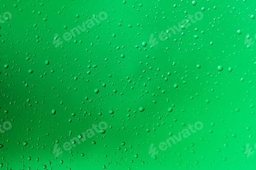 Preview: Closeup view of waterdrops on a glass pane with green background