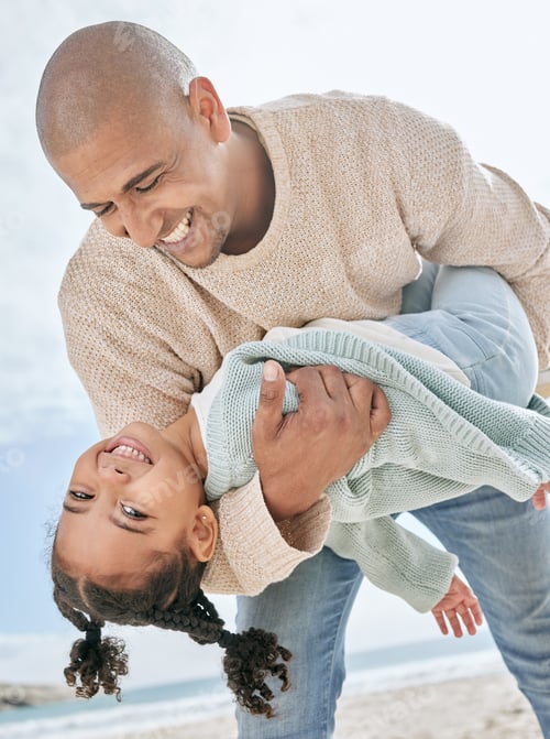 Preview: Smiling mixed race single father carrying little daughter on the beach. Adorable, happy, latin girl